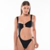 Model wearing the Sirena Black swimsuit by Acuarela Brand , bandeau top and high-cut design.